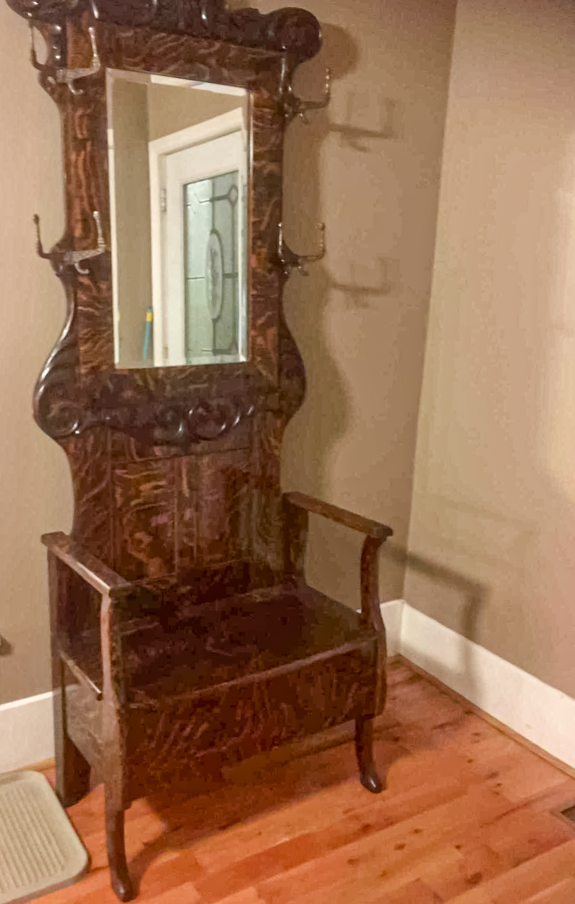 Antique wooden hall tree with mirror.